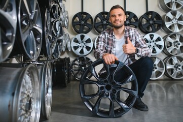 A male customer in a car rim shop