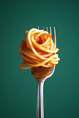 A fork with a twirl of spaghetti against a green background. Perfect for food blogs, recipe websites, and culinary magazines.