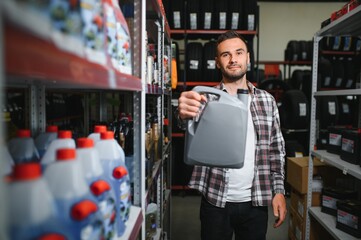 Man put motor oil for car engine in store