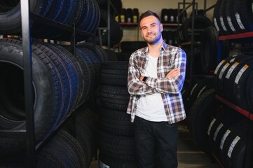 Fototapeta premium Man chooses winter car tires in the auto shop