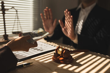 Lawyer, businessman or accountant is refusing money and resisting the partner's bribery agreement...