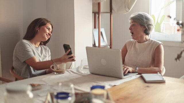 Mother and daughter enjoying a chatty moment with gadgets
