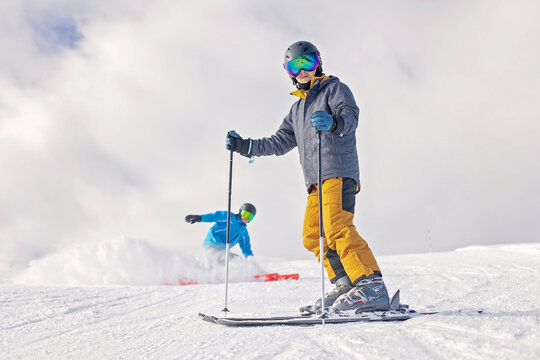 Children and adults, happy family in winter clothing at ski vacation, skiing, winter