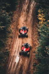 Muddy off-road race with two ATV riders driving through a dense forest.