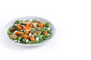 Pumpkin salad with arugula, walnuts and feta cheese isolated on white background. Copy space