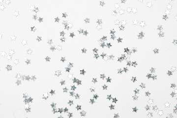 Fototapeta premium sparkles silver stars on white background with text place- Image