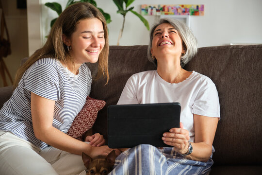 Mother and daughter enjoying time together with tablet