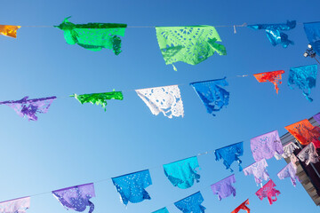 Vibrant Mexican Papel Picado Flags Under Blue Sky