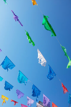 Vibrant Mexican Festival Flags Against Blue Sky