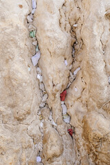 Tiny prayer notes inserted into the cracks and crevices of the Western Wall holy site in Jerusalem, Israel.