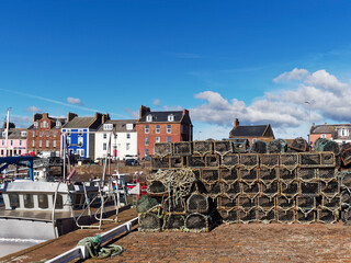 Stacks of Creels for Lobster and Crab Fishing stacked up on the traditional stone and cobbled...