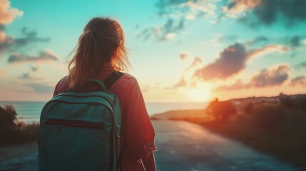 Fototapeta premium Woman with a backpack watching a beautiful sunset by the sea, symbolizing travel, adventure, and the beauty of nature.