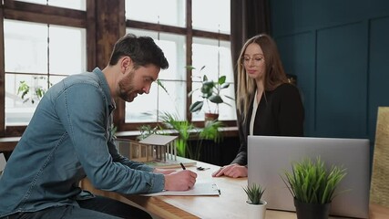 Man sign mortgage contract, put signature on sale purchase rental agreement, handshaking realtor at meeting with estate agent, satisfied customers buy property, get keys of new home.