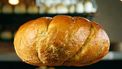 360 degree video of a crusty, golden brown baguette rotating in a french bakery, lit with three-point lighting