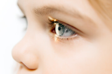 In a modern ophthalmology clinic, an ophthalmologist checks a little girl's vision using a binocular slit lamp in close-up. An example of contemporary techniques for children's vision correction.