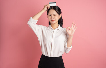 Fototapeta premium portrait of Asian business woman posing on pink background