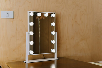 A stylish vanity mirror with bright bulbs, perfect for makeup application and grooming. Its modern design complements any room decor beautifully