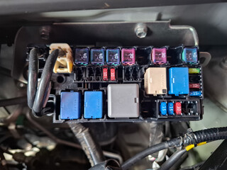 a box containing fuses and electrical relays for car vehicles