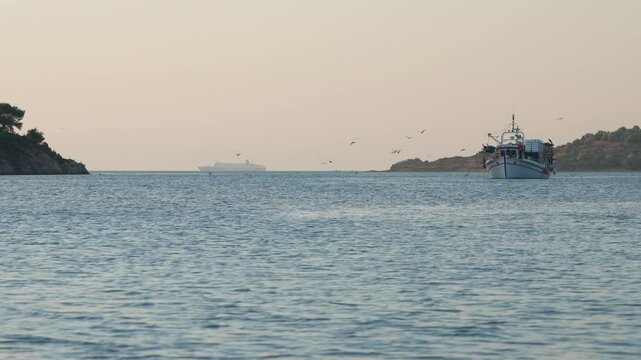 fishing boat returning from a night fishing in the morning. June 5, 2024 at the port in the fishing village of Pirgi Lesbos, Greece