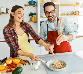 woman couple man pregnant food cooking preparing ingredient kitchen pregnancy happy love fresh diet mother preparation lunch meal healthy cook