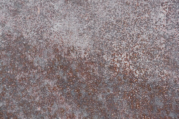 Corroded metal surface. Texture of a heavily rusted metal surface with remnants of white paint, close-up, high resolution.