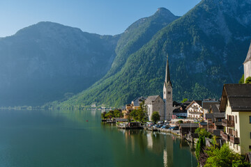 Serene morning in Hallstatt, Austria with mountains reflecting on tranquil lake waters