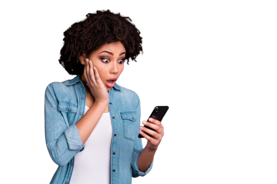 Portrait of astonished youth reaction stupor scream shout get news unbelievable unexpected omg touch hand chin hold device wear modern denim clothes isolated grey background - Powered by Adobe