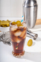 Cola and pickled cucumber cold iced sweet sour soda drink