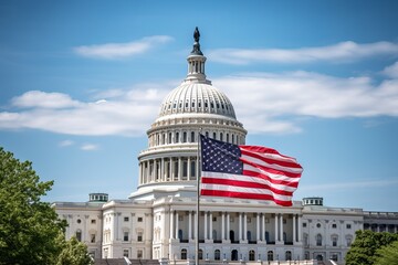 Obraz premium American flag waving in front of the United States Capitol during a sunny afternoon