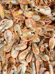 Lots of frozen unpeeled shrimp top view