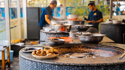 traditional oriental Arabic Uzbek pilaf with meat in a cauldron. Central Asian Pilaf Center in Uzbekistan in Tashkent