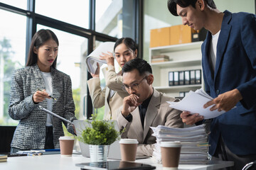 Asian business team is angry and blames the colleague for poor work, the team failure is not satisfied with the report.