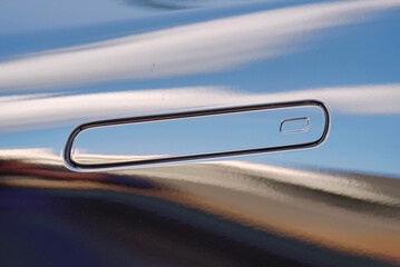 Obraz premium Hidden black car door handle closeup. Minimalistic hidden door handle design on black car, futuristic and smooth door opening system for luxury vehicles. Selective focus