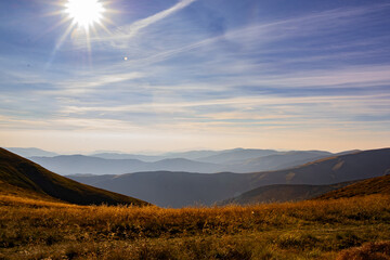 The sun is shining over the mountains.
