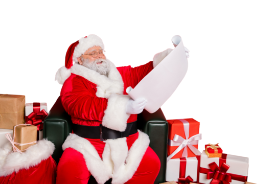Portrait of his he nice cheerful kind generous fat bearded man St Nicholas reading address list clients wish want fairy miracle orders winter december isolated over bright vivid shine red background