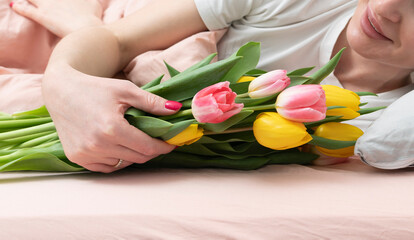 A young beautiful girl received a bouquet of flowers and a congratulatory letter on a wonderful...