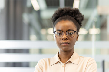 Confident professional woman in office showcases leadership, determination, and focus. Image highlights modern business environment with emphasis on individual strength and ambition.