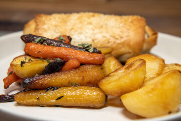 A delicious plate of Jackfruit, stage and Onion strudel on a wooden restaurant table