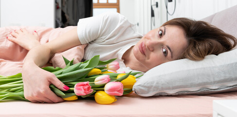 A young beautiful girl received a bouquet of flowers and a congratulatory letter on a wonderful...