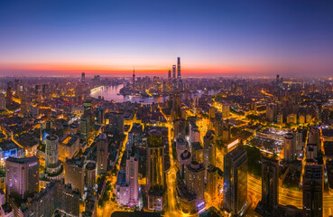 Aerial view of modern city skyline and buildings at sunrise in Shanghai