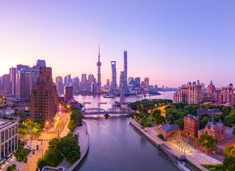 Aerial view of modern city skyline and buildings at sunrise in Shanghai