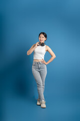 Portrait of beautiful Asian woman posing on blue background.