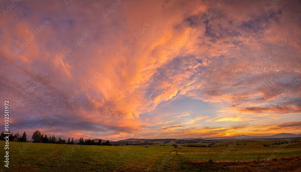 Wall mural beautiful,dramatic sky illuminated by the sun during sunset-panorama