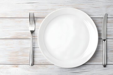 A simple white plate on a minimalist wooden table, with a knife and fork neatly placed beside it