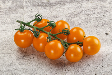 Yellow sweet tomato on the branch