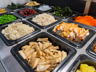 Freshly prepared ingredients arranged neatly in containers, perfect for customizing delicious meals or salads.