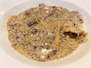 Delicious creamy Italian Ravioli dish featuring mushrooms in a rich sauce, perfect for gourmet dining experiences and culinary delights.