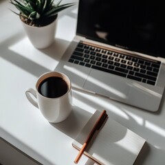 a laptop, coffee and a plant on a desk