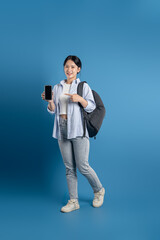 Portrait of beautiful Asian woman posing on blue background.