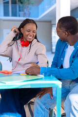 Multiracial college assignments and learning classes studying sitting around the university campus.Vertical 